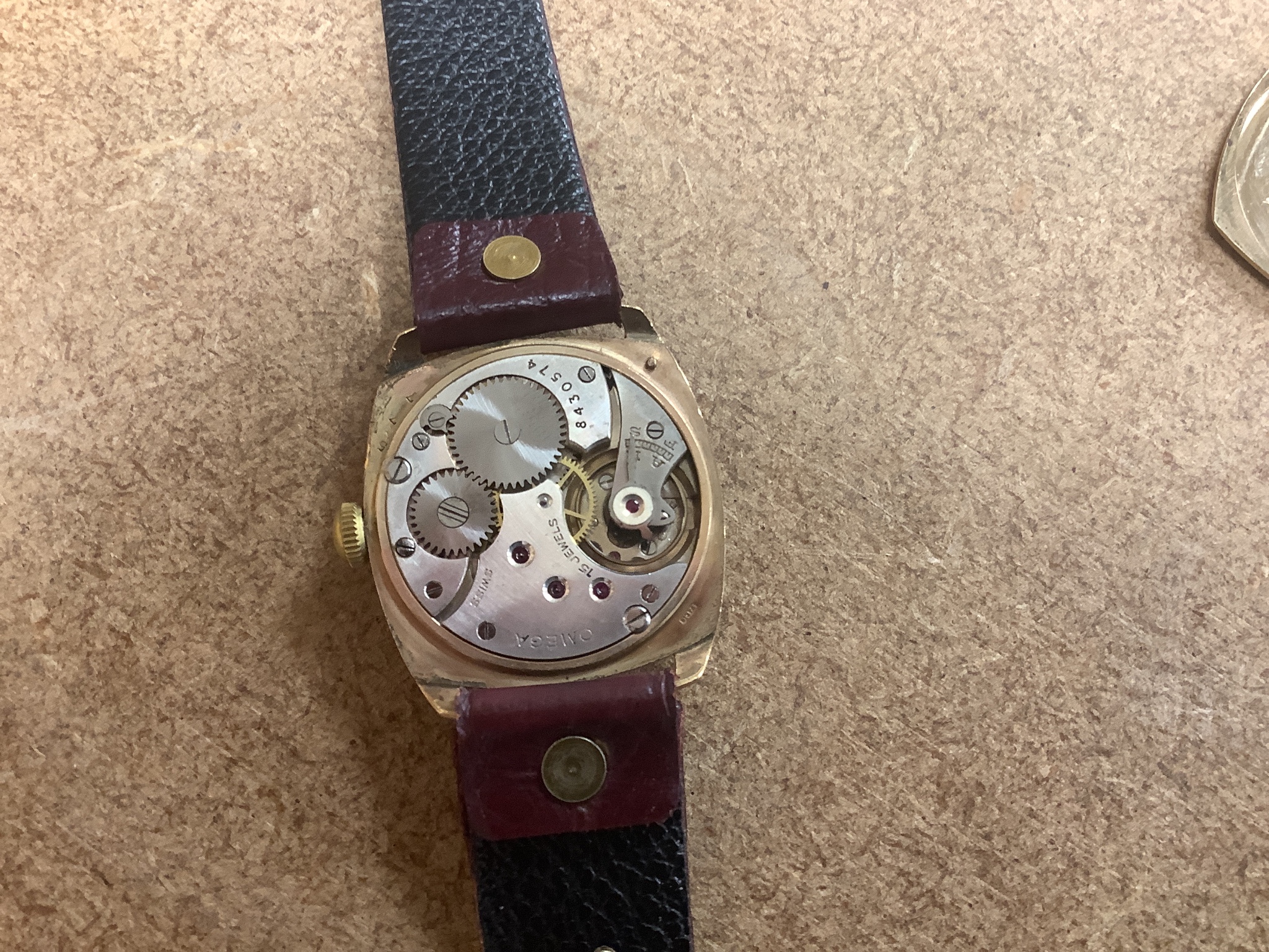 A gentleman's 9ct gold Omega cushion case wrist watch with silvered Arabic dial, monogrammed on the back and dated 1938